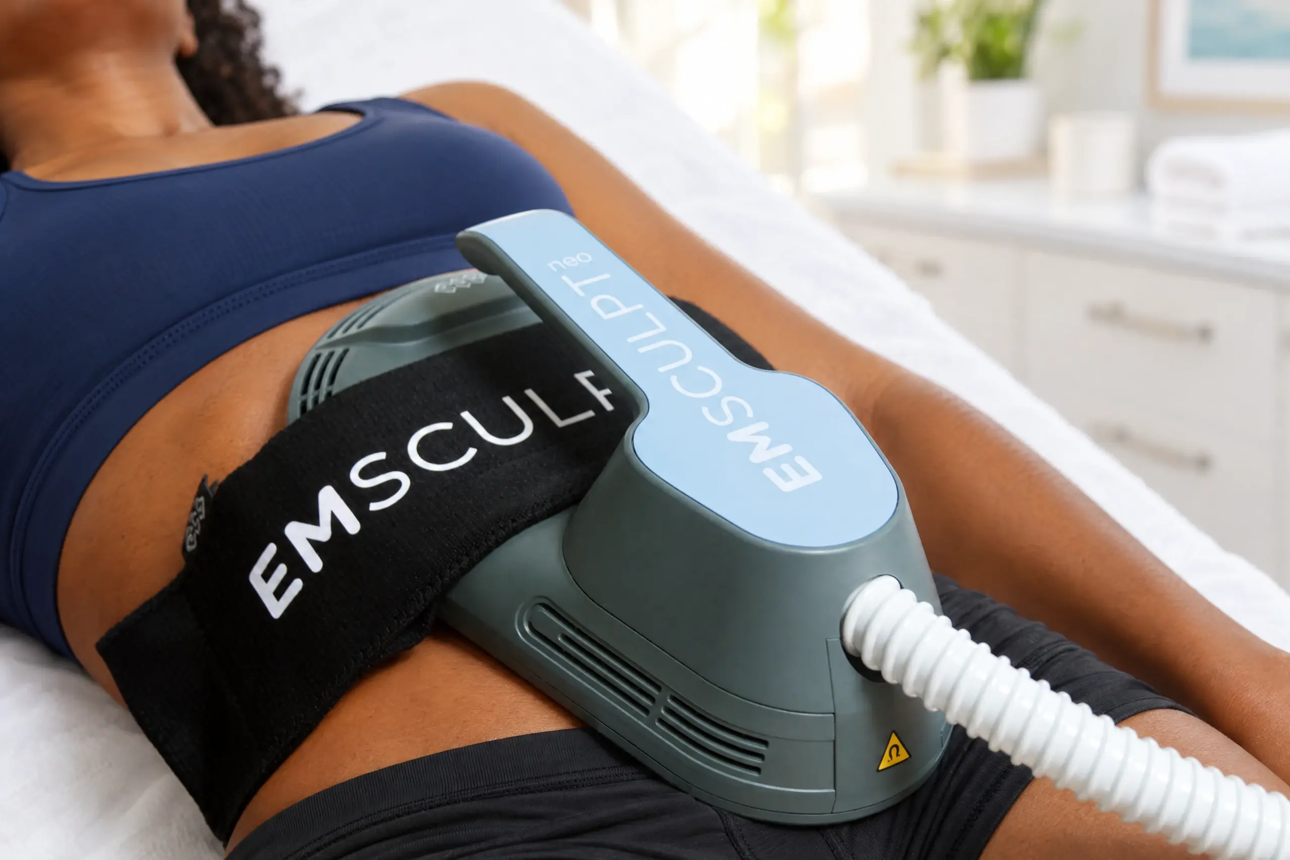 Emsculpt NEO applicator on a patient’s abdomen during a Core to Floor session at Ready Pain Management in Gulf Breeze, FL